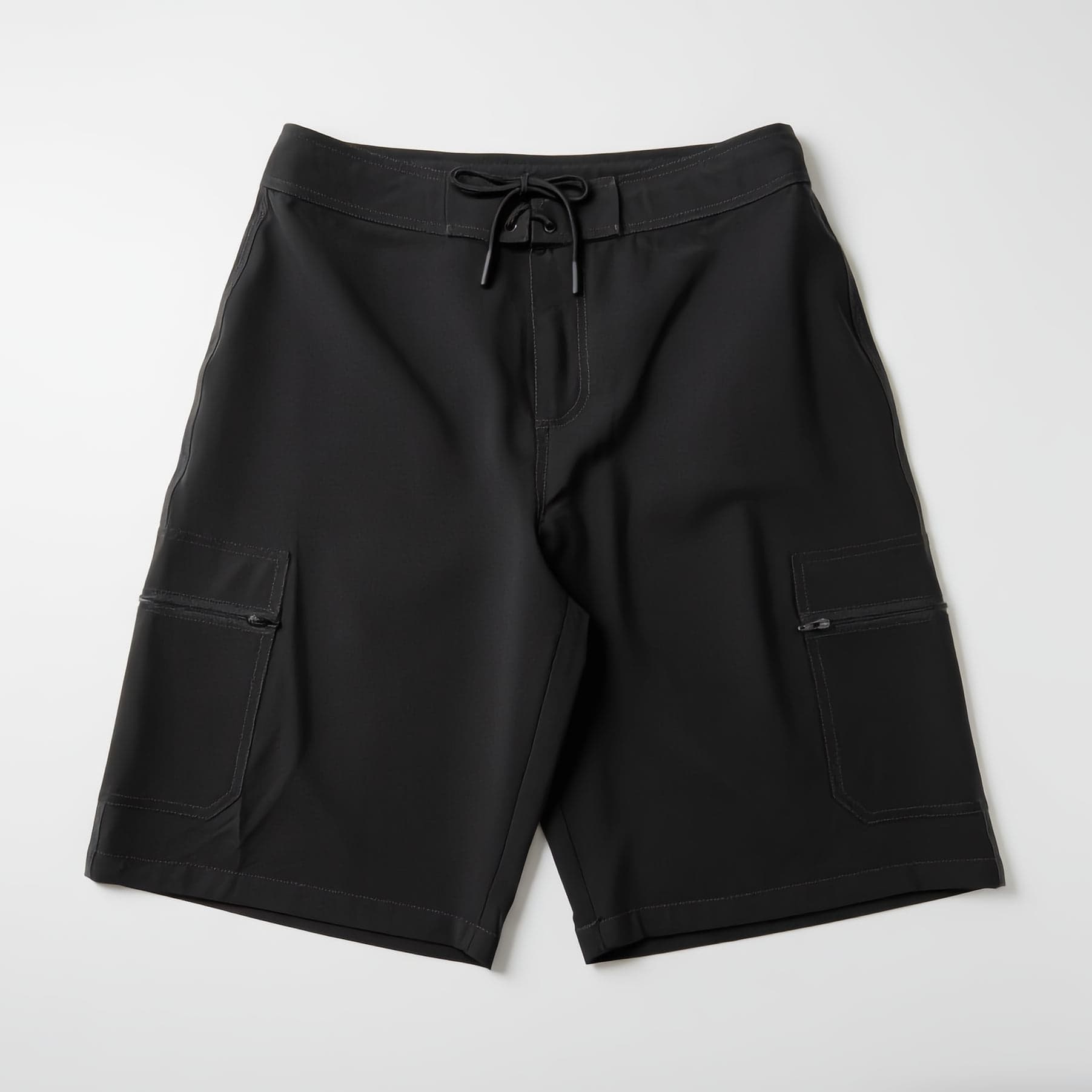 LODI Original Boardshort in Charcoal, laid flat, front view: lace-tied waistband and a flap pocket with a zip on each thigh.